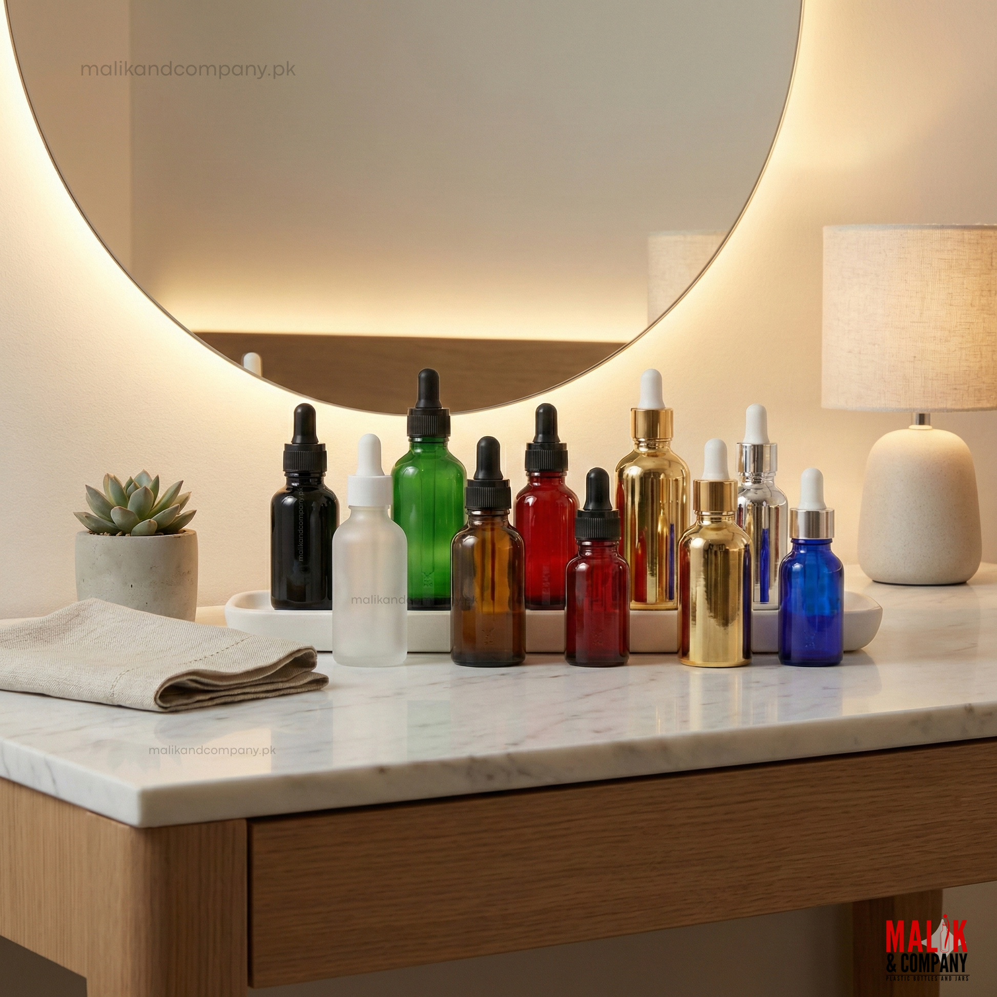 Assorted colored glass dropper bottles for cosmetic serums and essential oils, featuring amber, green, frosted, blue, and metallic gold finishes on a marble vanity